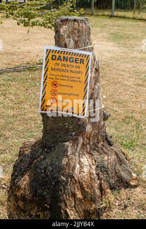 Windsor, Berkshire, UK. 28th July, 2022. Following the body of a man being recovered from the River Thames near Baths Island in Windsor last week, new danger signs have been put up next to the River Thames warning people of the dangers of swimming and diving into the River Thames. Credit: Maureen McLean/Alamy Live News Stock Photo