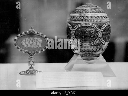 The World's Most Beautiful Easter Egg Queen Mary's Art Treasures -- The Easter egg of platinum, gold, diamond, by the Russian jeweler Carl Faberge is in one of the cases being displayed in the Exhibition of Queen Mary's Art Treasures, being held at the Victoria and Albert Museum, London. Alongside it is a jeweled stand bearing portraits of Czar Nicholas 11's five children, given by the Czar to the Czarina at Easter 1914. The exhibition opens tomorrow - Queen Mary's birthday, remaining open until December 31. May 25, 1954. (Photo by Ronald Ockenden, United Press Photo). Stock Photo