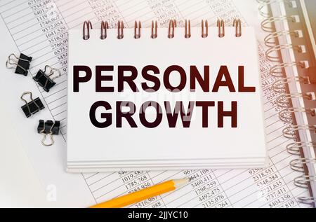 Business concept. On the table is a pen and a notebook with inscriptions - PERSONAL GROWTH Stock Photo