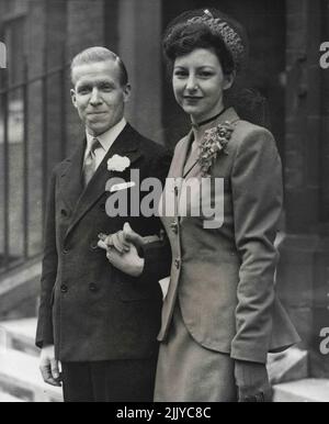 Picture Shows: The bride and bridegroom leaving St. Columba's, Pont Street, London, to-day (Thursday) after the ceremony. At the Church of Scotland (St. Columba's Pont Street, London) the Hon. William Buchan, heir to Lord Tweedsmuir of Elsfield Manor, Oxford, was married to-day (Thursday) to Miss Barbara Howard Ensor. December 05, 1946. Stock Photo