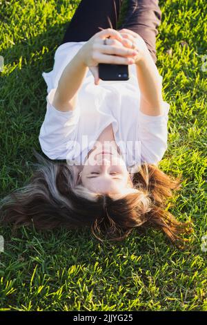 Teenage girl with a smartphone in her hands. View from above Stock Photo