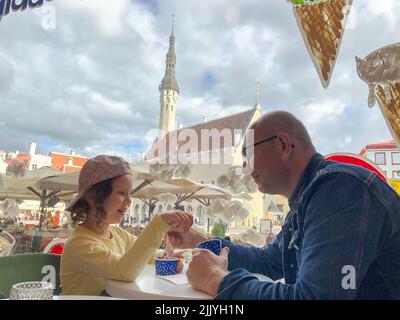 The family eats ice cream in a cafe, dad and daughter. Stock Photo