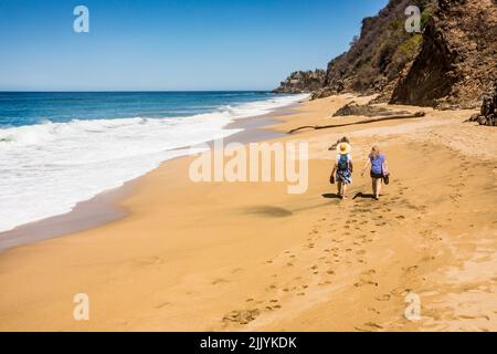 Two women walking Playa Malpaso near Sayulita, Nayarit, Mexico. Stock Photo