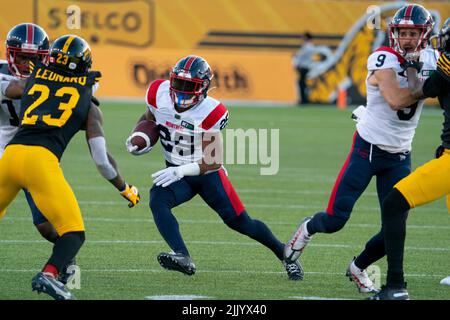 Montreal Alouettes wide receiver Reggie White Jr (84) carries the ball past  Hamilton Tiger-Cats defensive back Cariel Brooks (26) during first half  exhibition CFL football action in Hamilton on Saturday, May 28