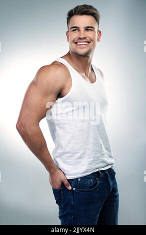 Somethings on my mind and it might be you. Studio shot of a handsome young man posing against a grey background. Stock Photo