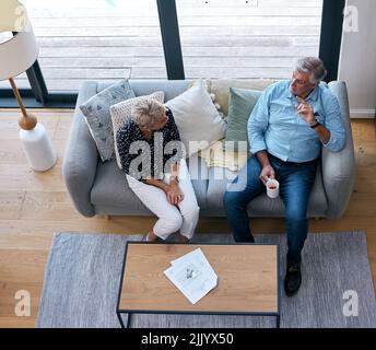 Theres a lot to discuss. a senior male realtor going through paperwork with a client. Stock Photo