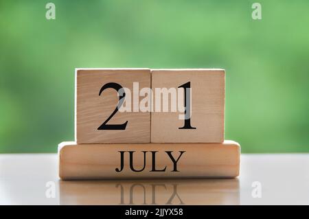 July 21 calendar date text on wooden blocks with blurred background park. Concept Stock Photo