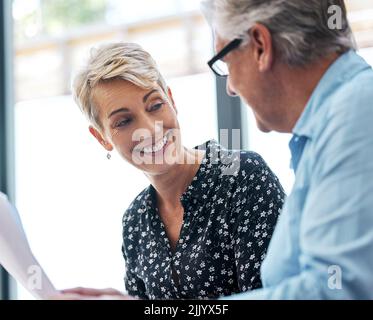 He can help you with any legal matter. a senior male realtor going through paperwork with a client. Stock Photo