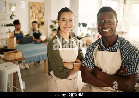 Fashion, design and style with diverse designers and professional team members with arms crossed and working in a creative workshop. Confident textile Stock Photo