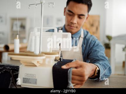 Fashion designer, young man and tailor in a creative workshop to sew clothes and garments. Factory worker, student and apprentice learning sewing Stock Photo