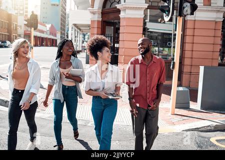 Casual, diverse students walking in the city and chatting or having fun together in town during a university campus break. Cheerful, happy group of Stock Photo