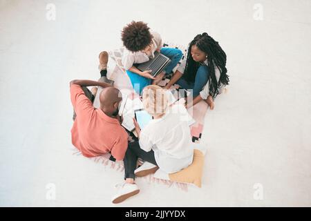 Teamwork, unity and support with diverse group students from above. Brainstorming and planning a creative strategy while working on a project. Young Stock Photo
