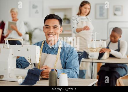 Fashion, design and style with a young designer working in a startup on a sewing machine in a workshop. Busy and creative designer creating new Stock Photo