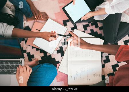 Creative, teamwork and busy people working on strategy planning and brainstorming project ideas together from above view. Student group doing digital Stock Photo