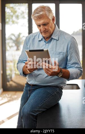 Always looking for the best properties. a senior male realtor using a digital tablet. Stock Photo