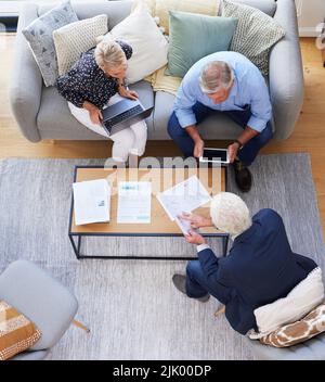 This is important to remember. Aerial shot of a group of businesspeople going through paperwork. Stock Photo