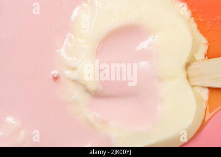 top view cats paw shape peach and cheese flavor popsicle melted on pink close up Stock Photo