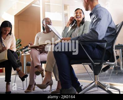 Meetings make us successful. a diverse group of businesspeople sitting in the boardroom during a meeting. Stock Photo
