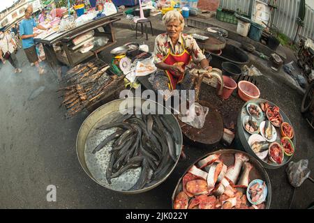 PHICHIT , THAILAND - AUGUST 29,2020 : Unidentified elderly vendors sell grilled catfish and a variety of fresh fish in the morning market. Stock Photo