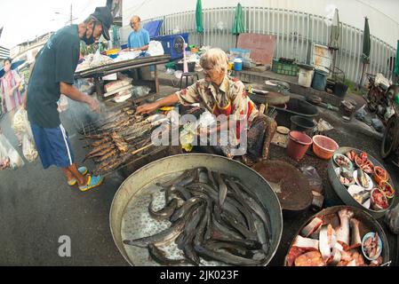 PHICHIT , THAILAND - AUGUST 29,2020 : Unidentified elderly vendors sell grilled catfish and a variety of fresh fish in the morning market. Stock Photo