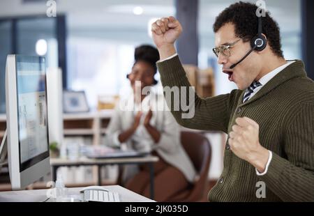 Success is attainable through hard work. a two colleagues celebrating success in an office at work. Stock Photo