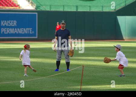 Washington, DC, USA. 28th July, 2022. U.S. Rep. Eric Swalwell (D-Cal.) plays catch with his two children on the field before the 2022 Congressional Baseball Game at Nationals Park. Credit: Philip Yabut/Ģ����ý Live News Stock Photo
