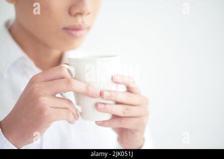 Cropped image of young man drinking cup of coffee Stock Photo