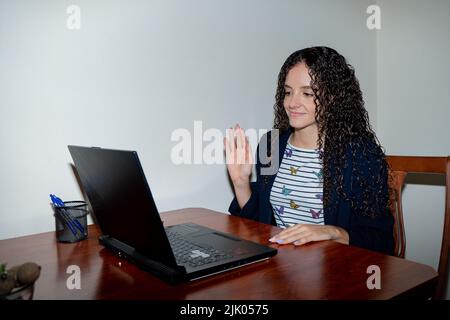 Young woman working from home doing a videoconference Stock Photo
