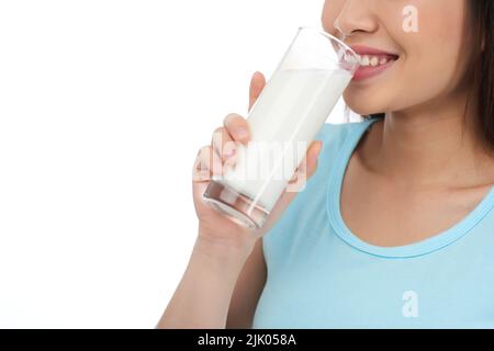 Close-up shot of cheerful young woman drinking milk white standing against white background Stock Photo