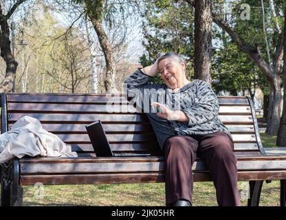 using technology and social media older people can communicate with each other from any corner of globe. multitasking, business concept. Grandparents Stock Photo