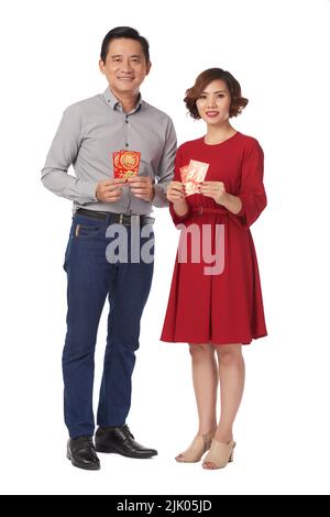 Happy Vietnamese man and woman holding lucky money envelopes Stock Photo