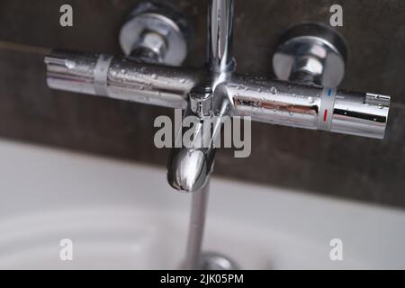 Chrome faucets on white ceramic bathtub in bathroom Stock Photo