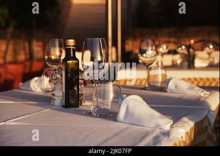 Table setting for dinner in open space during sunset Stock Photo