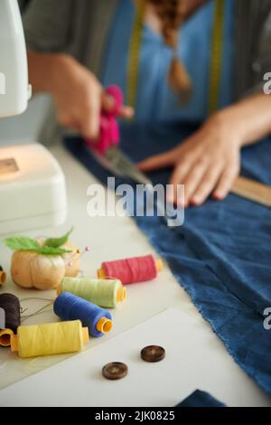 Colorful threads and buttons on table of tailor Stock Photo