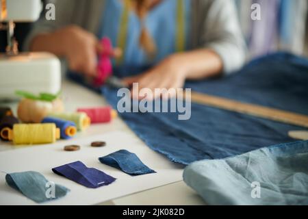 Samples of blue fabric on table of working tailor, selective focus Stock Photo