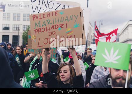 05.28.2022 Warsaw, Poland. Young European Polish people during marijuana pro-legalization march in downtown Warsaw. Appetite after smoking weed concept. High quality photo Stock Photo
