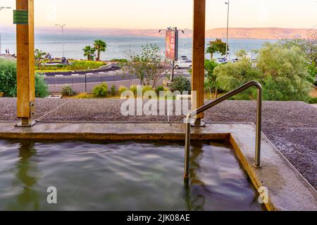 Tiberias, Israel - July 27, 2022: View of a Hot Water wading pool, and the Sea of Galilee, in Hamat Tiberias National Park, Northern Israel Stock Photo