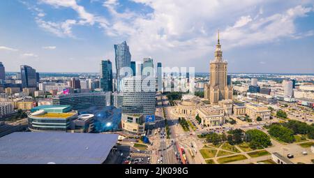7.22.2022 Warsaw, Poland. Summer holidays in European city. Beautiful weather and blue sky. Palace of Culture and Science and other skyscrapers seen from panoramic drone aerial view. High quality photo Stock Photo