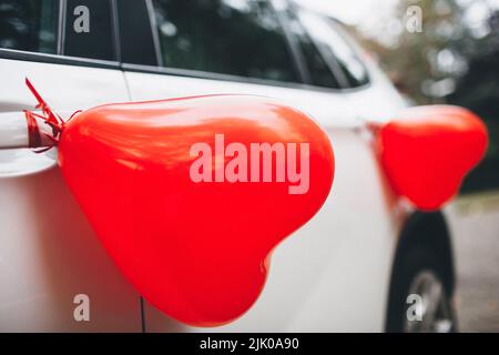 Wedding car decorated with balloons on the door. Stock Photo