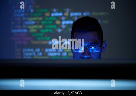 Software developer checking code on computer screen Stock Photo