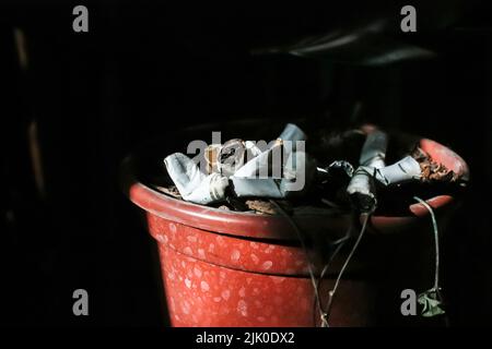Cigarette butts on a black background Stock Photo