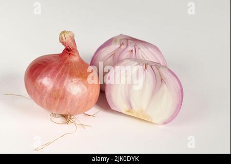 Red bulb onion and cut onion on a white background Stock Photo