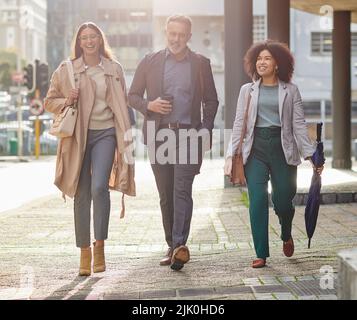 Ready to take the business world by storm. a group of colleagues walking around together. Stock Photo