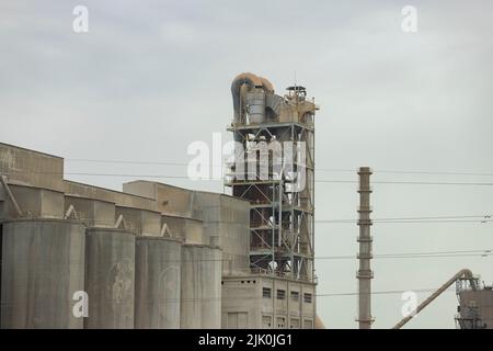 Factory. Cement factory seen from the outside on a cloudy day, in Spain. Europe. Horizontal photography. Stock Photo