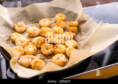 fried shrimps or prawns on parchment paper Stock Photo