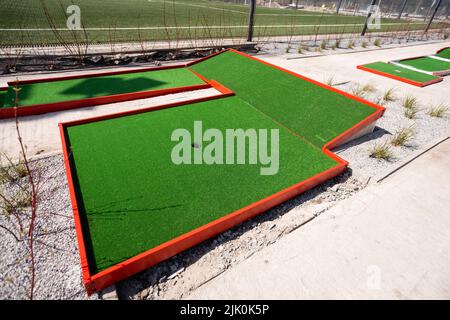 green artificial grass and rocks on miniature golf course Stock Photo