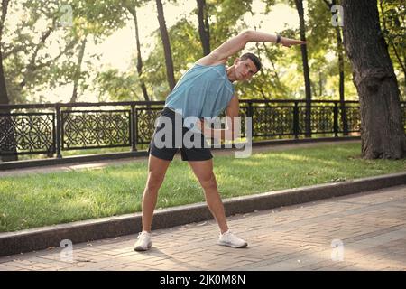 active man in sportswear making warm up exercise Stock Photo