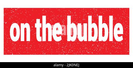 on the bubble text written on red grungy stamp sign. Stock Photo