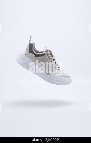 White with colours Athletic Sports Shoes suspended on the air with white background