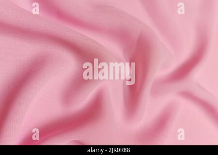 Pink chiffon fabric crumpled or wavy fabric texture background. Abstract linen cloth soft waves. Silk yarn. Smooth elegant luxury cloth texture Stock Photo